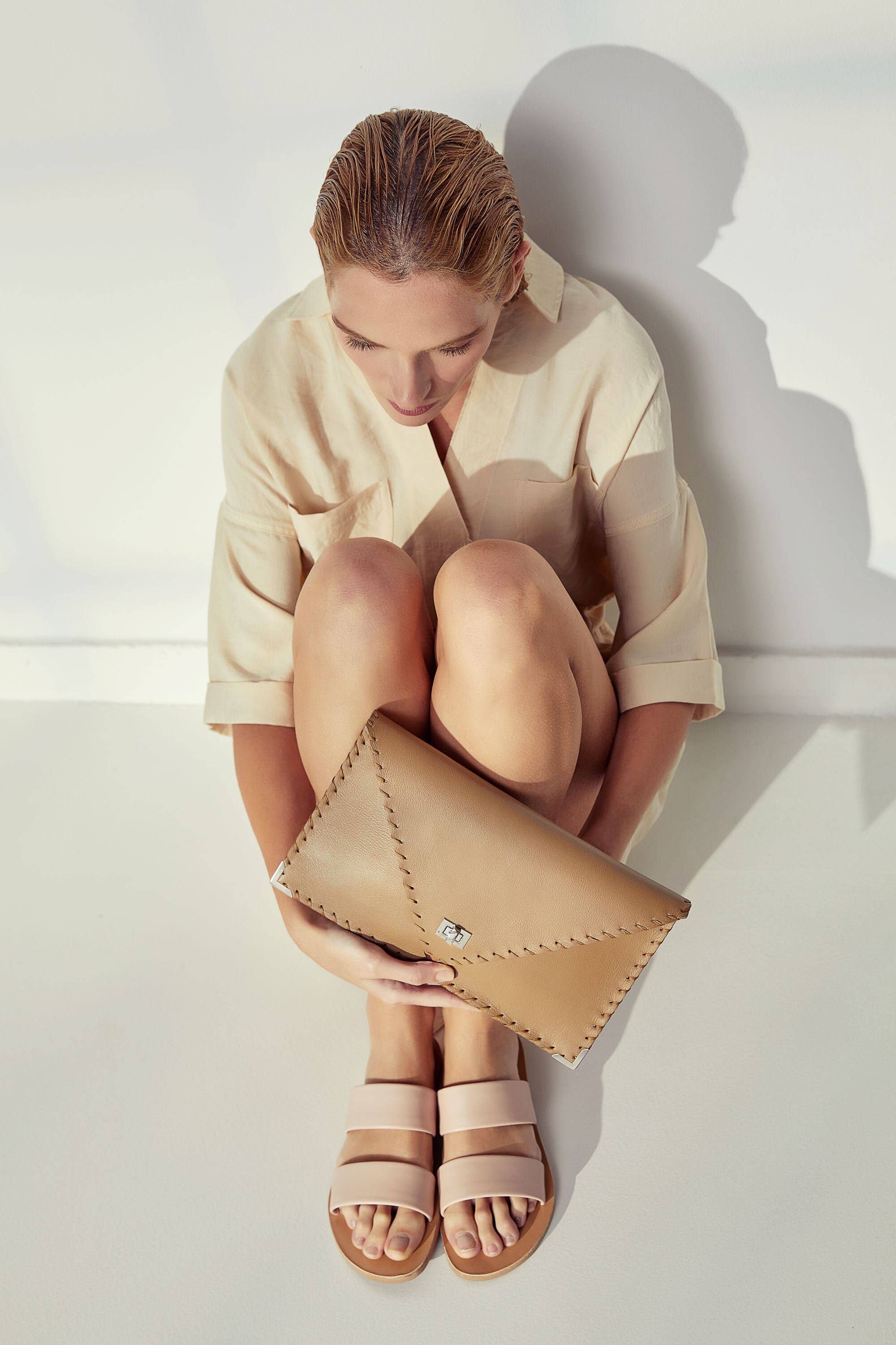 Symmetria leather clutch in sand beige