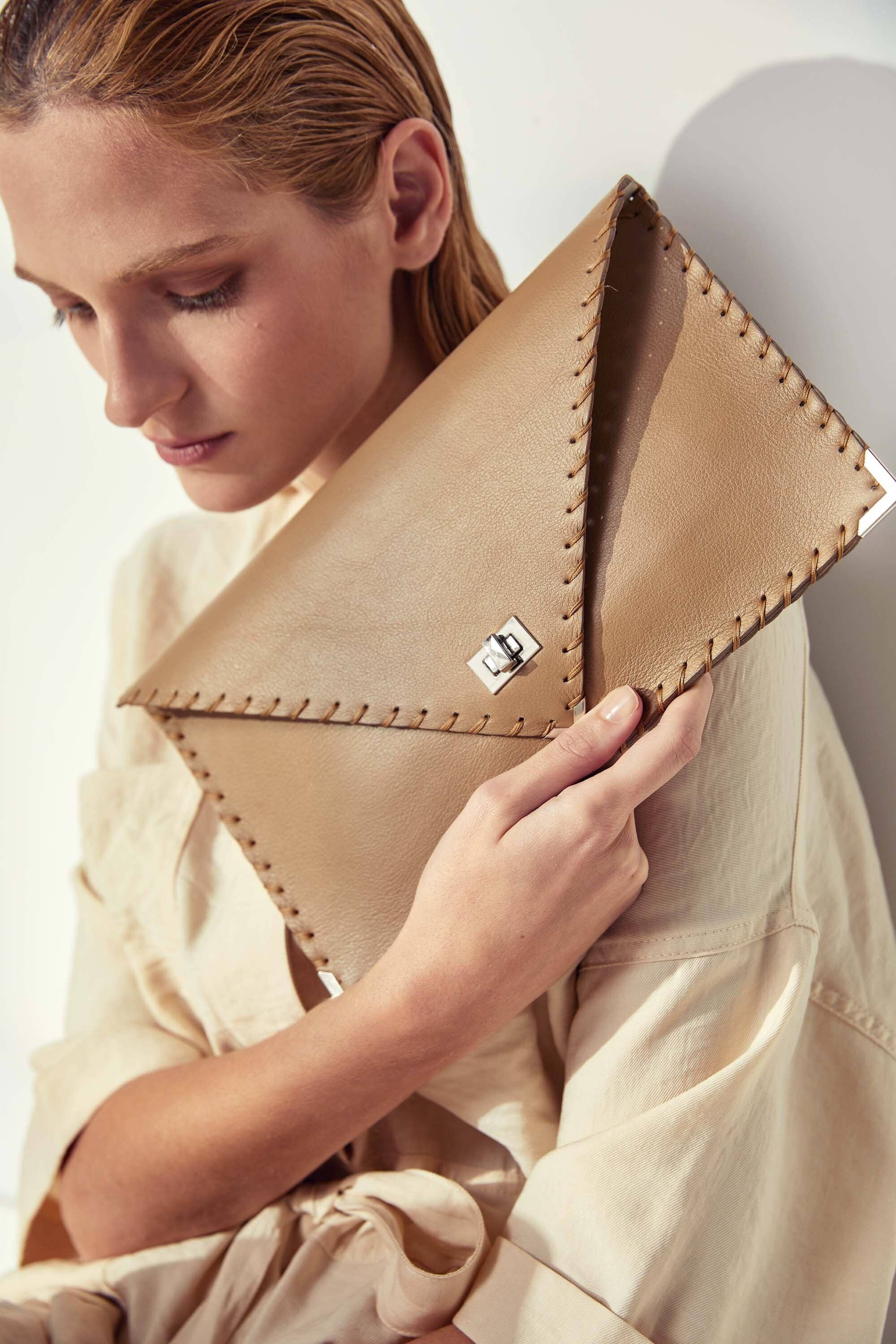 Symmetria leather clutch in sand beige